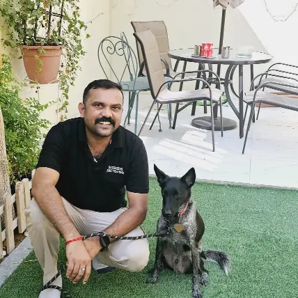 A man sitting beside a dog