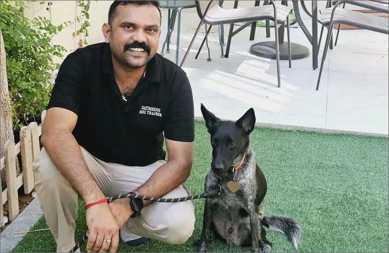 A man sitting beside a dog